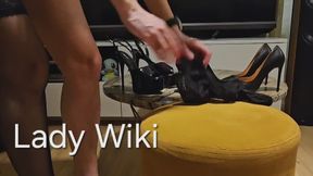 The lady puts on stockings and high heels in a sexy way