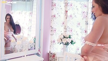 Gorgeous brunette, Sophia Delane is wearing lingerie while playing with her shaved pussy and tits