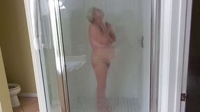 Sexy mature blonde granny takes a shower as we stepdaughter films