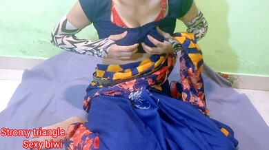Woman with orange hair spreads her shaved vulva on a gray cloth against a green wall