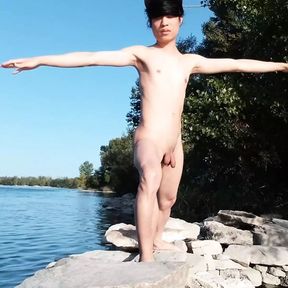 Gay twink does naked yoga outside on a rocky beach, gay cruising men passing by might watch him  Naked Asian boy doing yoga outd