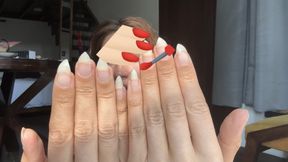 Nail Goddess sharpening her natural nails into claws