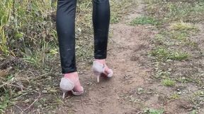 A girl in high-heeled shoes He walks through the mud and then falls on his knees there