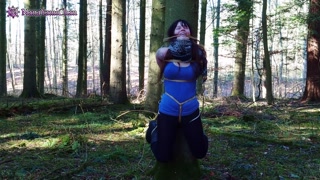 Girl bound in public to tree in forest and suspended; almost dicovered!