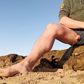 Pissing on the beach on the sunset