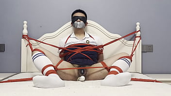 Asian boy tied to the bed, plugged by dildo and struggled