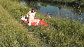 Wild Beach. Sexy Milf Platinum Naked Sunbathing On River Bank, Random Fisherman Guy Watches. Naked In Public. Nude Beach