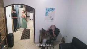While the husband works, the wife in a towel greets the delivery man