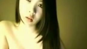 Slutty and hot Asian bitch with nice ass lays on the bed
