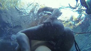 A blonde is getting her pussy rammed under the water in the pool