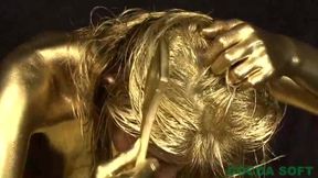 A beautiful woman is exercising with full body gold