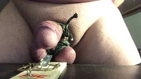 Mousetrap snapped on cock with hand cuffed behind back