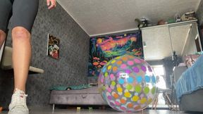 girl in sneackers jump on beachball