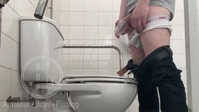 in the hospital toilets, a guy pisses into a cup for a urine sample, then gets horny, jerks-off and cums
