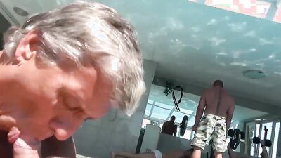 Perverted stepdad is sucking his stepson's cock by the pool
