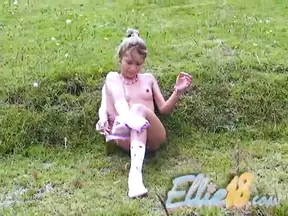 Ellie masturbating outdoors in solo action