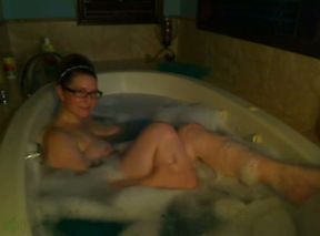 Kinky nerdy bosomy MILFie babe takes a foamy bath for me on webcam