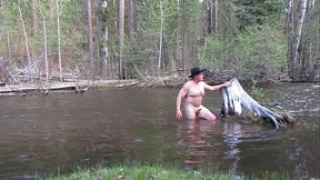 Bathing naked in the river.