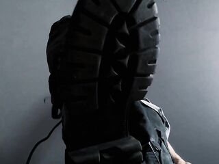 Feet fastened taut below coarse military boots