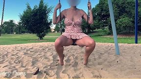 Busty housewife flashes bare pussy on park swing, public thrill seeker