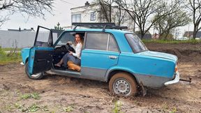 Chloe is stuck in a blue VAZ and spinning the wheels
