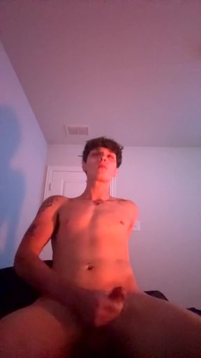 Young twink jacks it while lying down