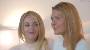Two pretty blonde models are about to do a striptease