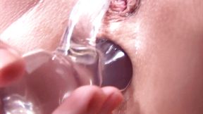Stripping off to fuck ass and pussy with glass dildo
