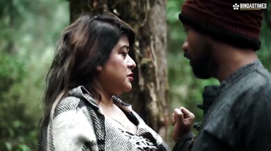 Dark-haired woman dances with bearded guide before intimate jungle encounter