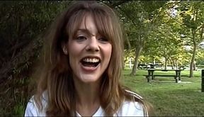 Brunette slut tugs guy's cock outdoors