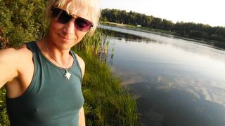 Swimming in the lake in fitness wear at sunset.. Moist stretch pants and t-tee-shirt...