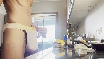 Skinny guy with a big dick in the kitchen showing off his dick size