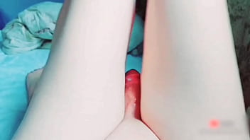 Cute sissy holding stuffed bunny in bed playfully