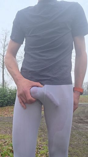 Skinny boy in white Wet Leggings shows his big bulge in public. Risky outdoor wanking his big cock
