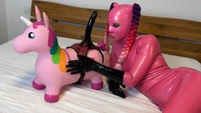 Latex slut rides rubber unicorn with a big black dildo