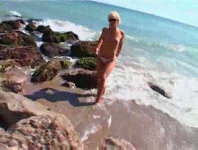 Sexy horny blonde hottie posing half naked on the beach