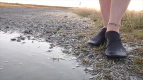 Bright Pantyhose and Beach Shoes in Puddle