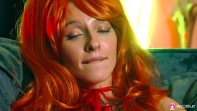 Horny redhead Stella Bliss plays passionately with a dildo on the couch.