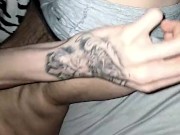 Touching and flexing my very skinny body showing my features in a dark room with flashlight on