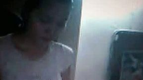 Some skinny Asian teen chick on webcam flashing her boobies