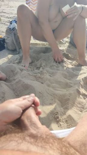 real couple shows off on public beach. my slut pisses topless in front of me so i jerk off