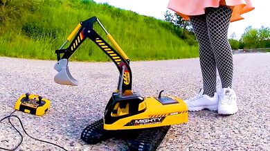 Big excavator trampled kicked crushed girl jumps on tiny car smashes plastic toy