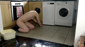 slave cleans kitchen floor in chains