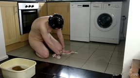 slave cleans kitchen floor in chains