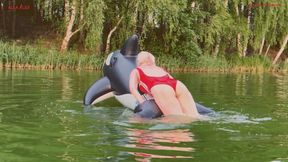 A fun game on the lake with a big, squeaky, naughty inflatable whale