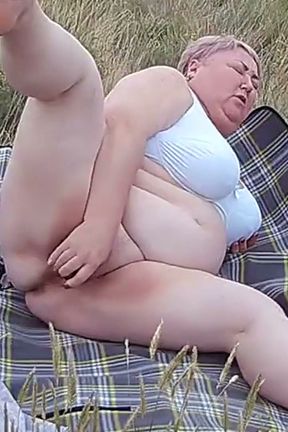 Bitch Masturbates Pussy With a Toy in the Field