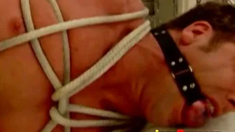 Muscular jock tied up and tormented with ropes and domination