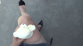 a small teddy bear sits astride my crossed legs Shpl