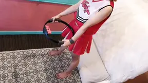 A married woman in a sexy cheerleader costume does some exercise as a