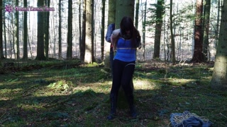 Girl bound in public to tree in forest and suspended; almost dicovered!